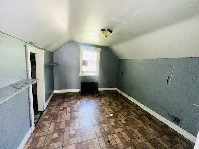 bonus room with lofted ceiling and radiator heating unit