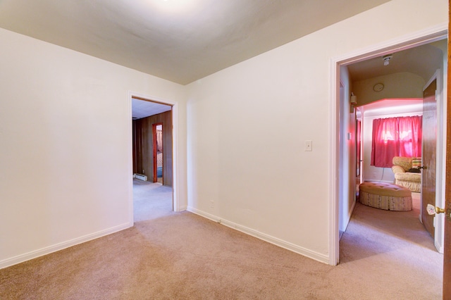 unfurnished room featuring light carpet