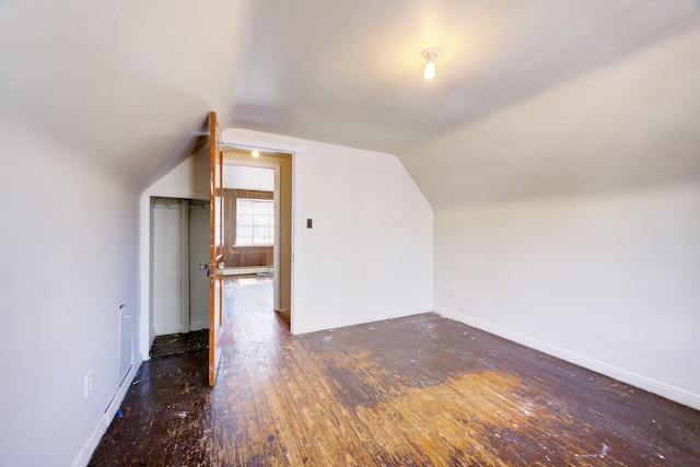 bonus room featuring dark hardwood / wood-style flooring and vaulted ceiling