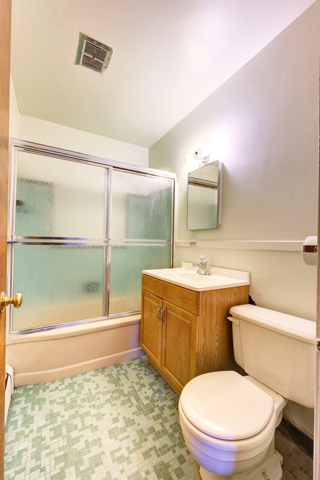 full bathroom with combined bath / shower with glass door, vanity, and toilet