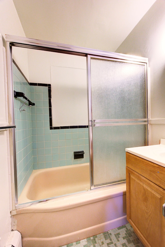 bathroom featuring shower / bath combination with glass door and vanity