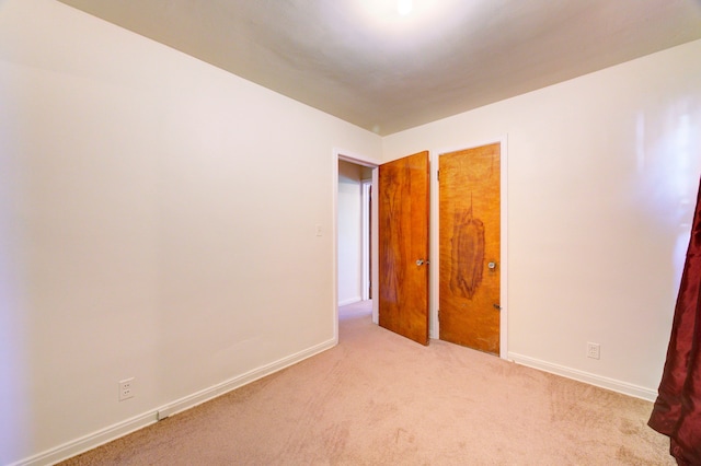 unfurnished bedroom with light colored carpet