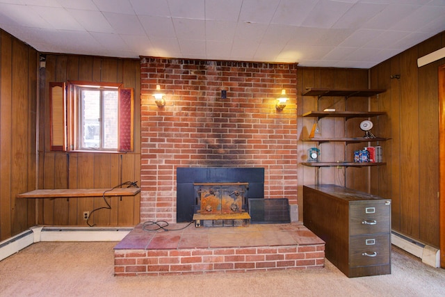 unfurnished living room with wood walls, a fireplace, carpet floors, and a baseboard radiator