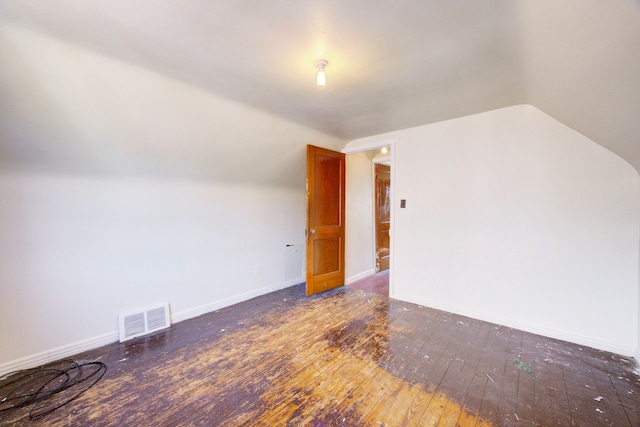 bonus room featuring dark hardwood / wood-style flooring and vaulted ceiling