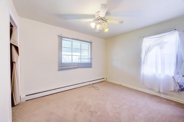 unfurnished bedroom with light colored carpet, ceiling fan, and a baseboard heating unit