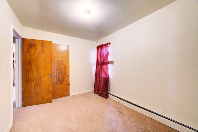 carpeted empty room with baseboard heating