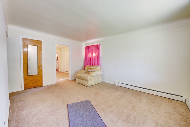 unfurnished room featuring carpet and a baseboard heating unit