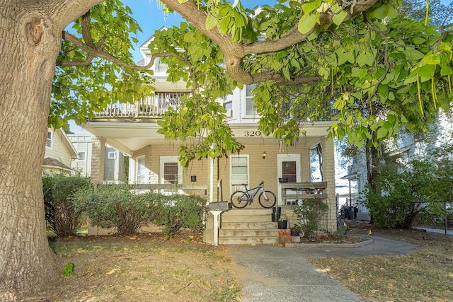 view of front facade featuring a balcony and a porch