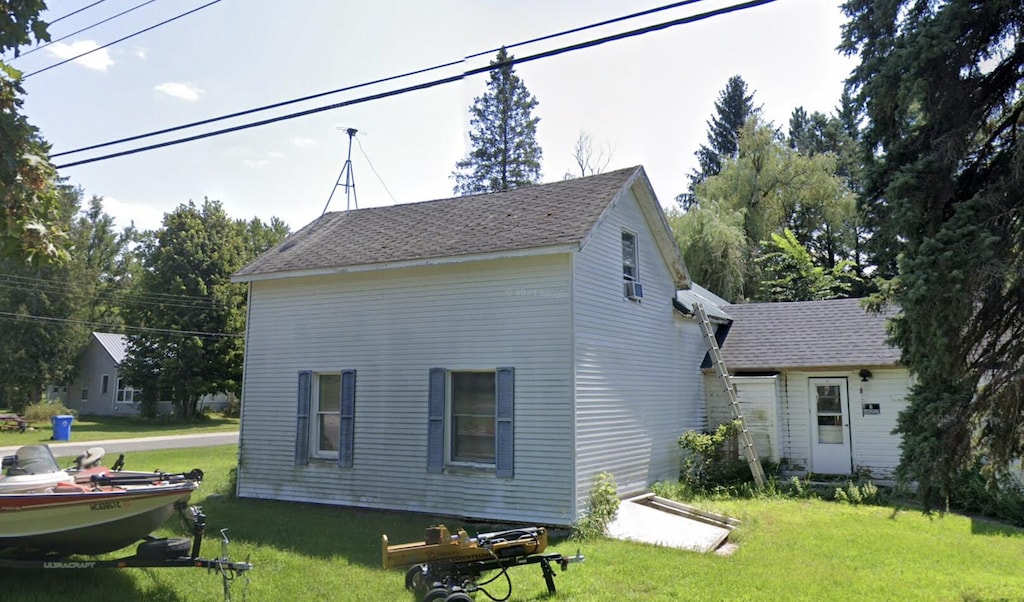 rear view of house with a lawn