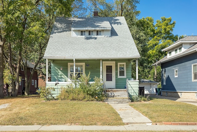 bungalow with a front lawn and a porch