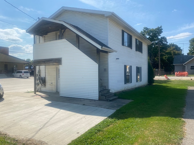 view of property exterior with a lawn