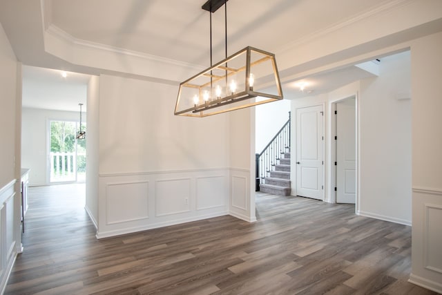 unfurnished dining area featuring dark hardwood / wood-style flooring and crown molding