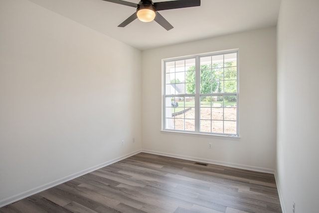 empty room with ceiling fan and wood-type flooring