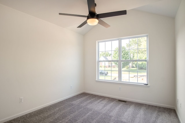 unfurnished room featuring carpet, plenty of natural light, and lofted ceiling