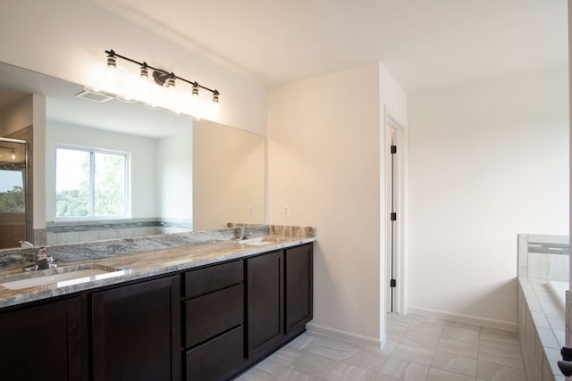 bathroom featuring vanity and a bath