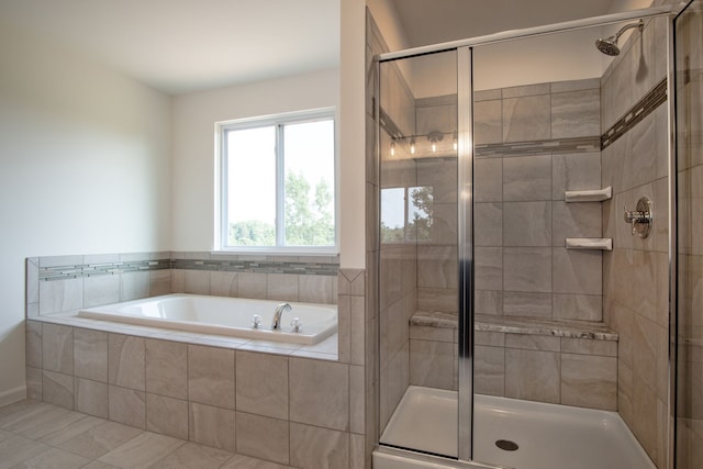 bathroom with separate shower and tub and tile patterned floors