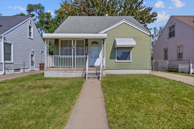 bungalow with a front yard and covered porch