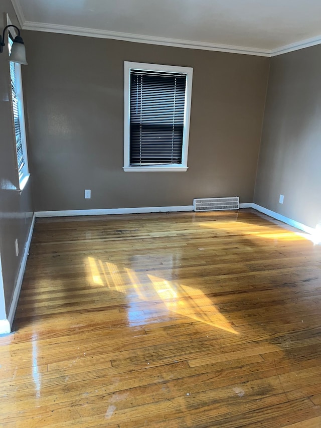 unfurnished room with hardwood / wood-style floors and ornamental molding