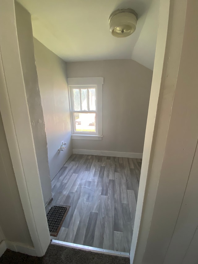 interior space featuring hardwood / wood-style floors and lofted ceiling