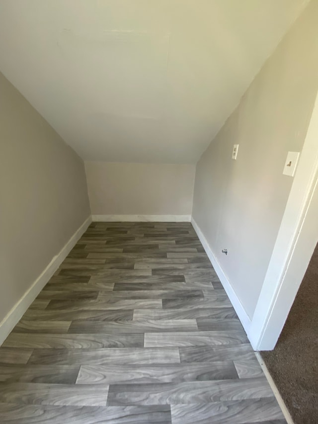 interior space with dark hardwood / wood-style floors and vaulted ceiling