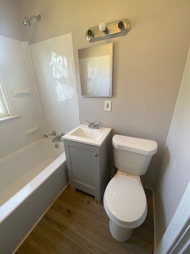 full bathroom featuring vanity, wood-type flooring, bathtub / shower combination, and toilet