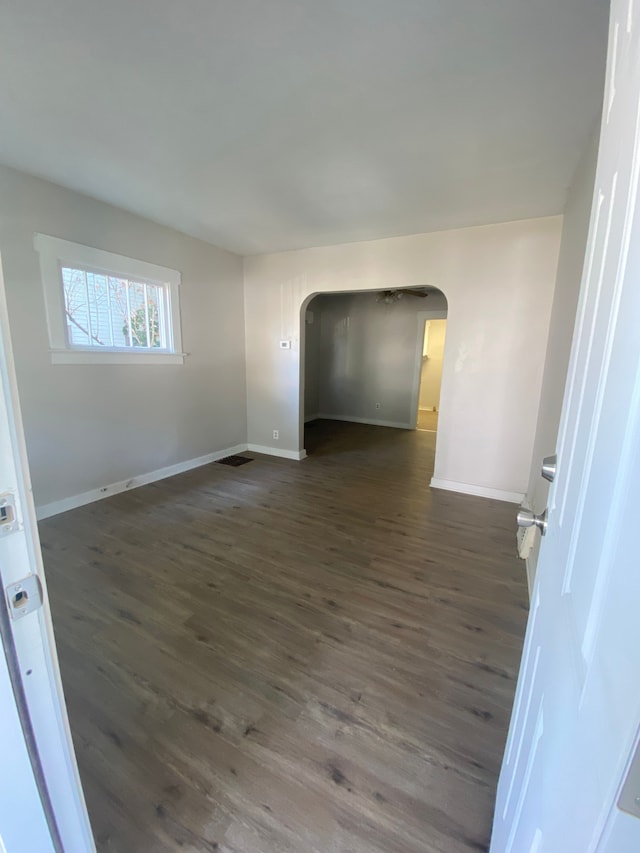 spare room featuring dark wood-type flooring