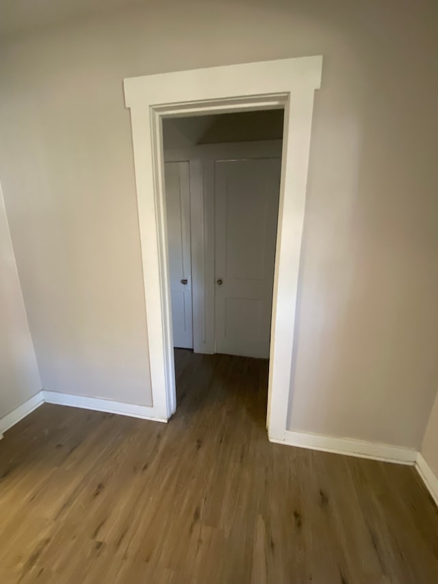 hallway with dark wood-type flooring