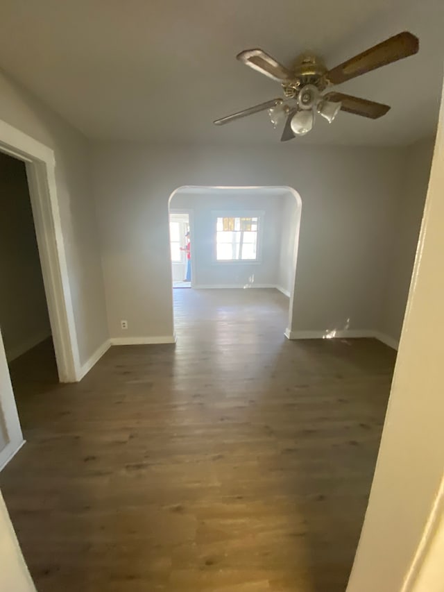 unfurnished room with ceiling fan and dark hardwood / wood-style flooring