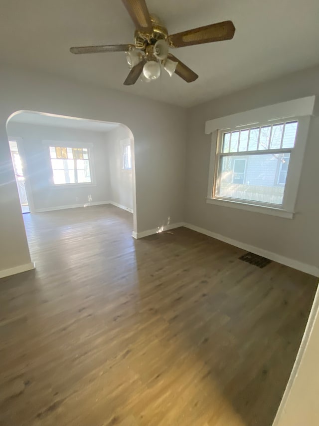 empty room featuring ceiling fan and dark hardwood / wood-style flooring