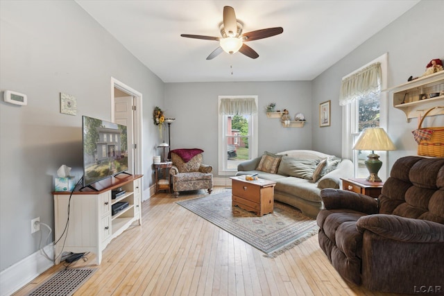 living room featuring light hardwood / wood-style floors and ceiling fan