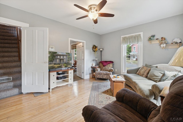 living room featuring ceiling fan and light wood-type flooring