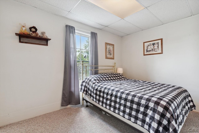 carpeted bedroom with a paneled ceiling