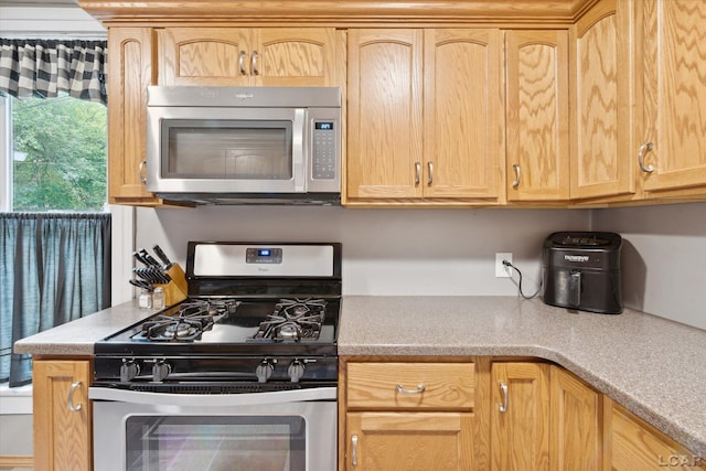 kitchen featuring appliances with stainless steel finishes and light brown cabinets