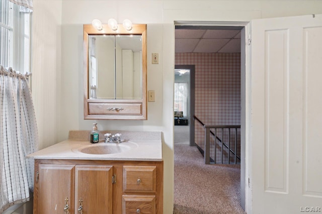 bathroom with a drop ceiling and vanity