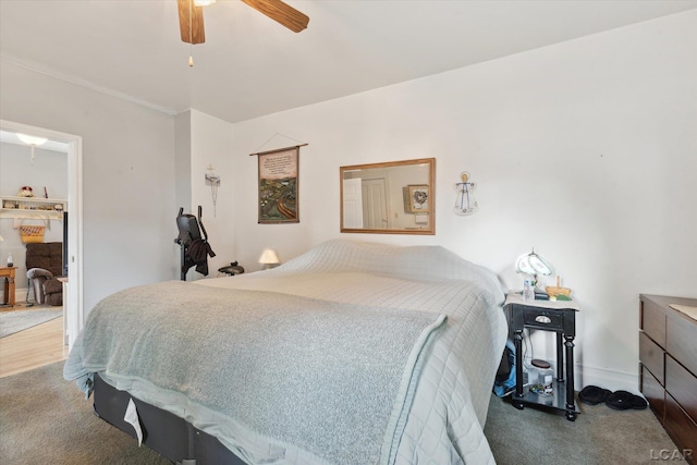 bedroom featuring ceiling fan and carpet