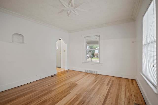 empty room with light hardwood / wood-style flooring and ornamental molding