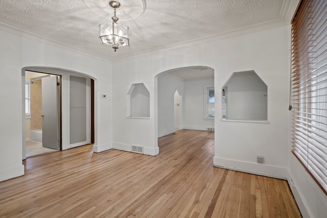 interior space featuring light hardwood / wood-style floors, a healthy amount of sunlight, and crown molding