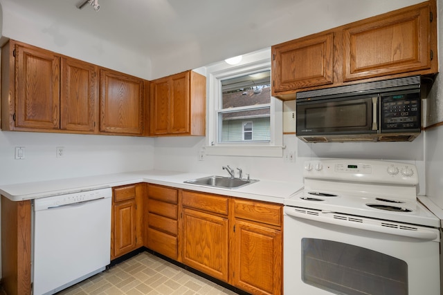 kitchen featuring sink and white appliances