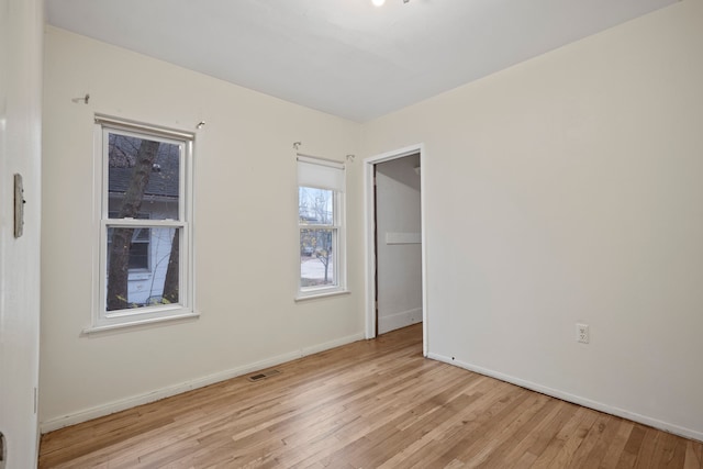 unfurnished room with light hardwood / wood-style flooring