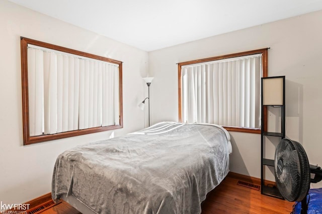 bedroom with hardwood / wood-style floors