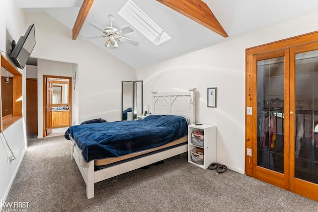 carpeted bedroom featuring french doors, ensuite bathroom, ceiling fan, and vaulted ceiling with skylight