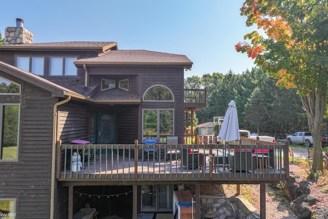 rear view of house featuring a deck