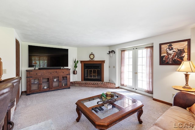 living room with french doors, light carpet, and a brick fireplace