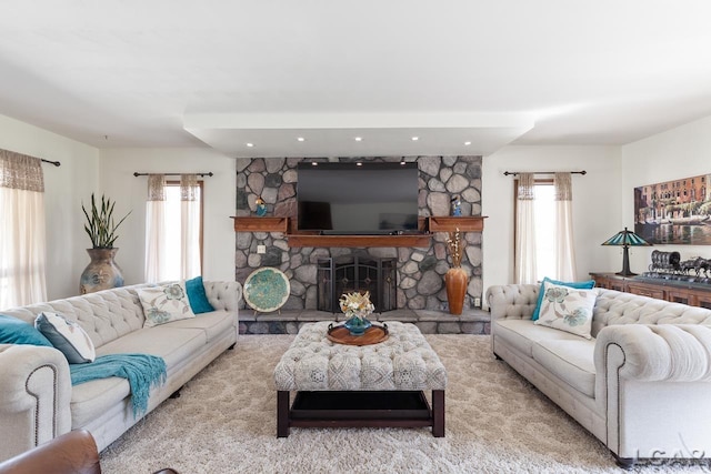 carpeted living room featuring a fireplace