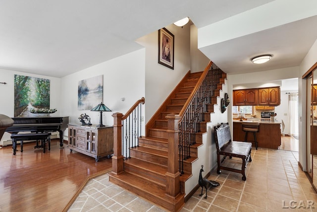 stairway featuring hardwood / wood-style floors and a healthy amount of sunlight