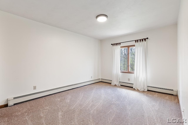 empty room featuring light carpet and baseboard heating