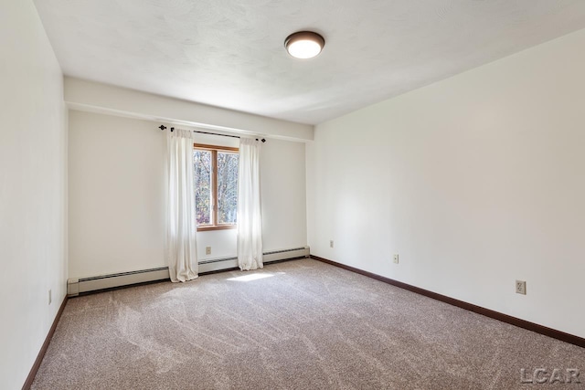 empty room with carpet floors and a baseboard heating unit