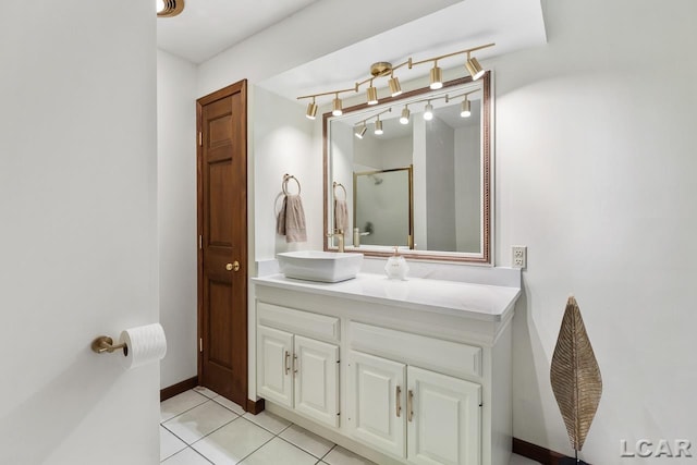 bathroom featuring tile patterned floors, a shower, and vanity