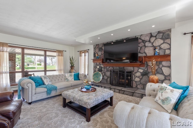 living room with a fireplace, light carpet, and a baseboard heating unit