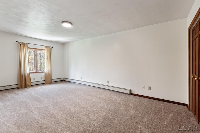 spare room featuring a textured ceiling, baseboard heating, and light carpet